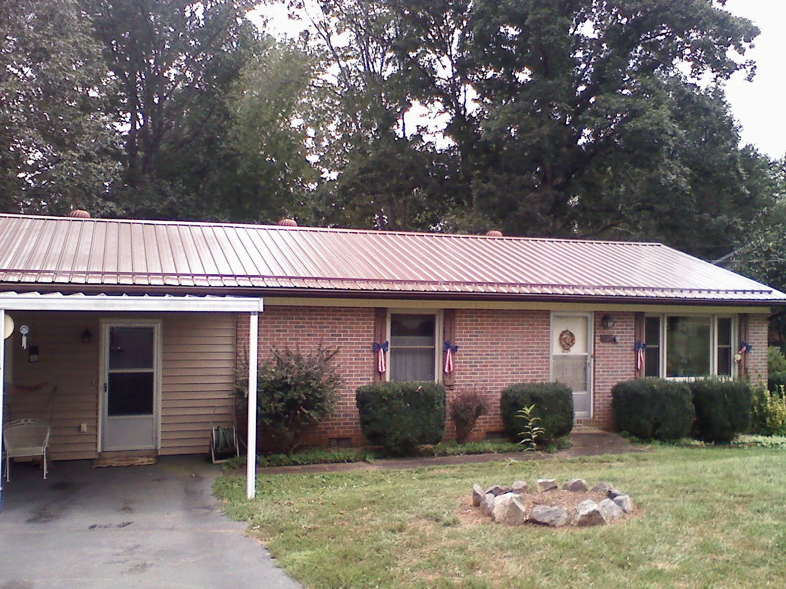Bronze metal roof and carport on a brick ranch home — Roof Repair work by our crew in Asotin